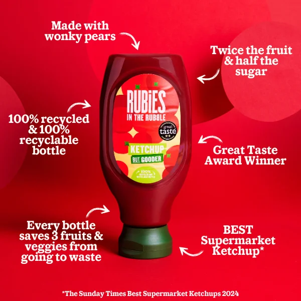 Image of the Rubies in the Rubble ketchup bottle with arrows pointing towards it stating the following claims: made with wonky pears, twice the fruit & half the sugar, 100% recycled & 100% recyclable bottle, Great Taste Award Winner, every bottle saves 3 fruits and veggies from going to waste, Best Supermarket Ketchup* *The Sunday Times Best Supermarket Ketchups 2024