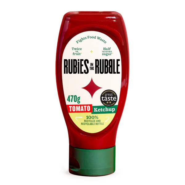 A bottle of Rubies in the Rubble tomato ketchup, emphasizing its food waste reduction, less sugar, recyclable packaging, and a 470g content label.